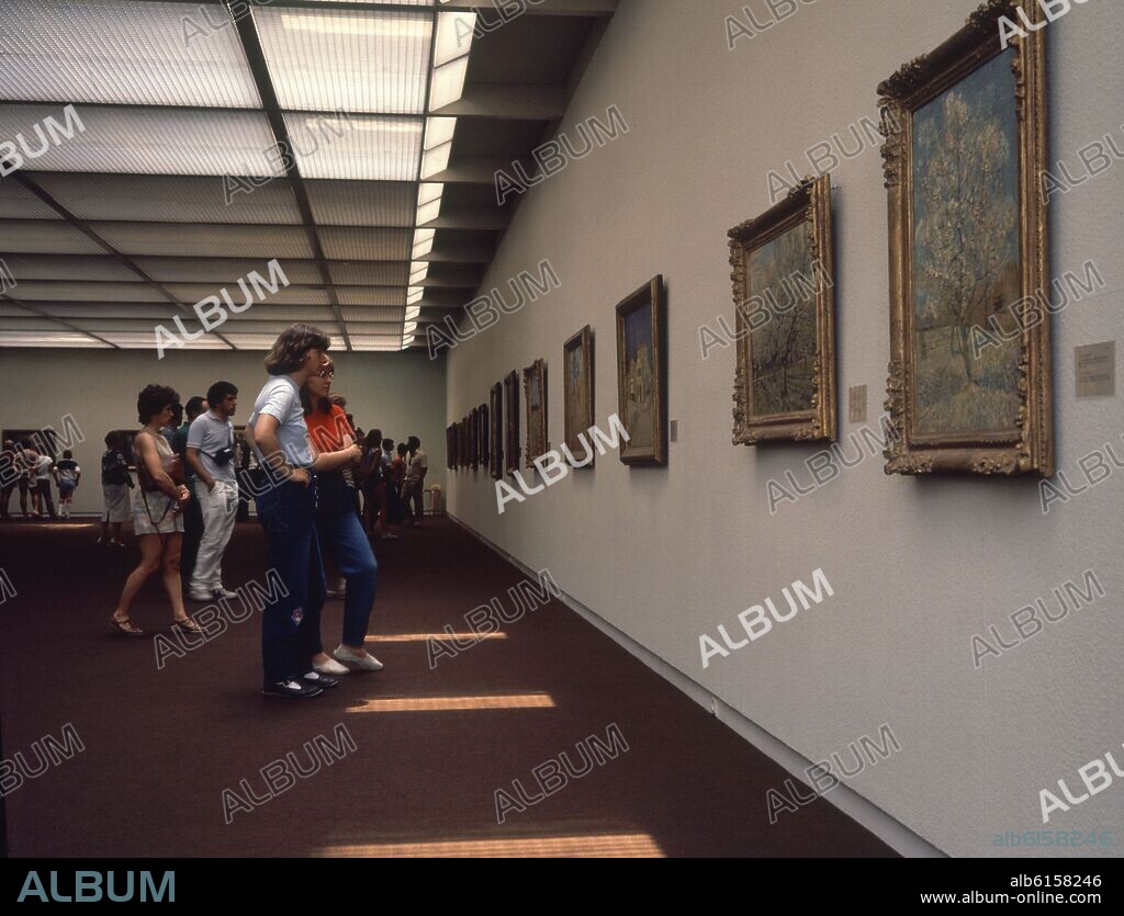 SALA DEL MUSEO CON GENTE MIRANDO CUADROS.