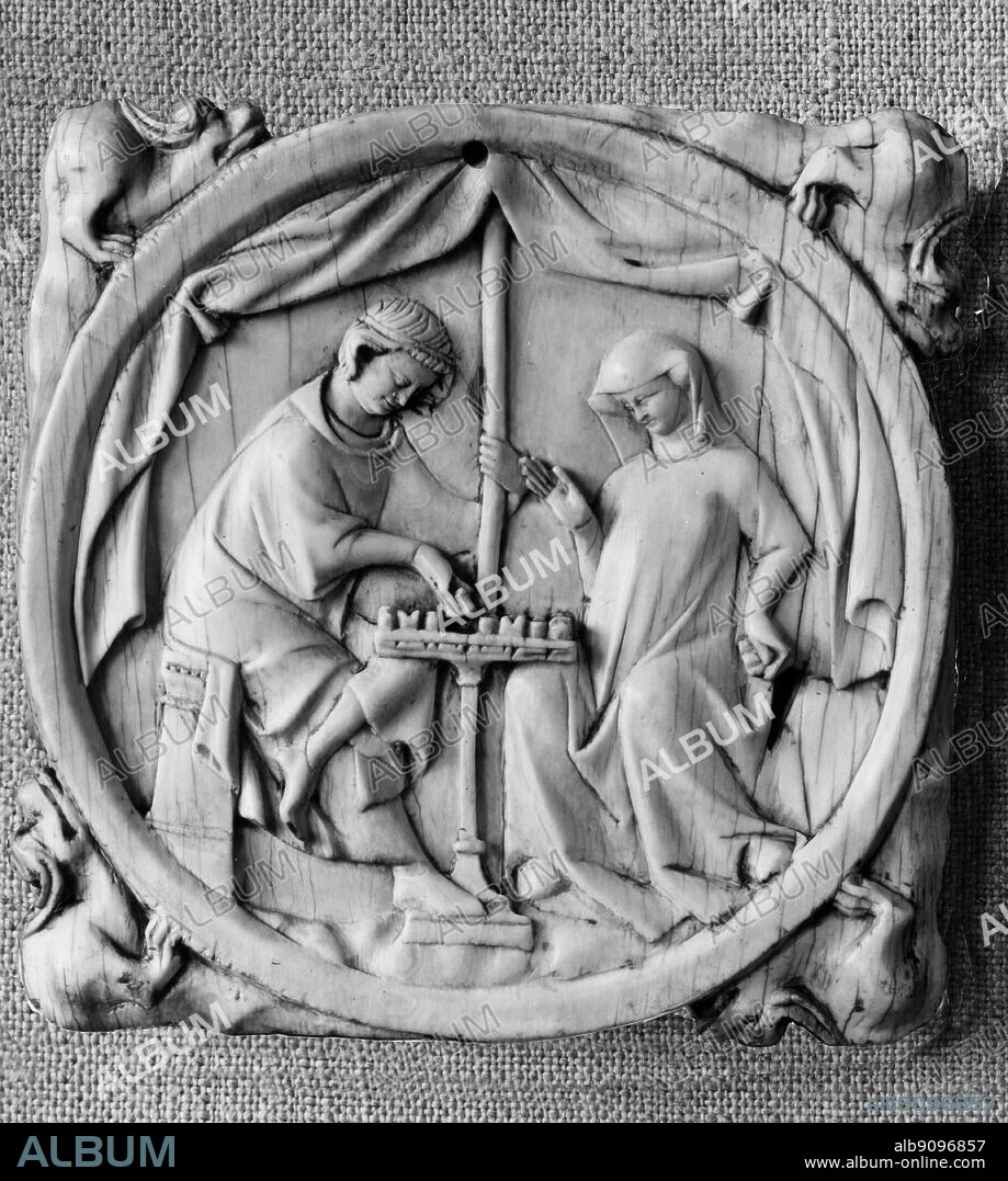 Daily Life - Carved , French , ivory mirror case showing chess game. Medieval scene. ©TopFoto.