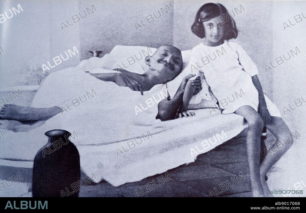 Mahatma Gandhi during a hunger strike is accompanied by Indira (Nehru) Gandhi, the daughter of Jawaharlal Nehru. Indira Gandhi later became Prime Minister of India. Mohandas Gandhi (1869 1948) was the preeminent leader of the Indian independence movement in British-ruled India.