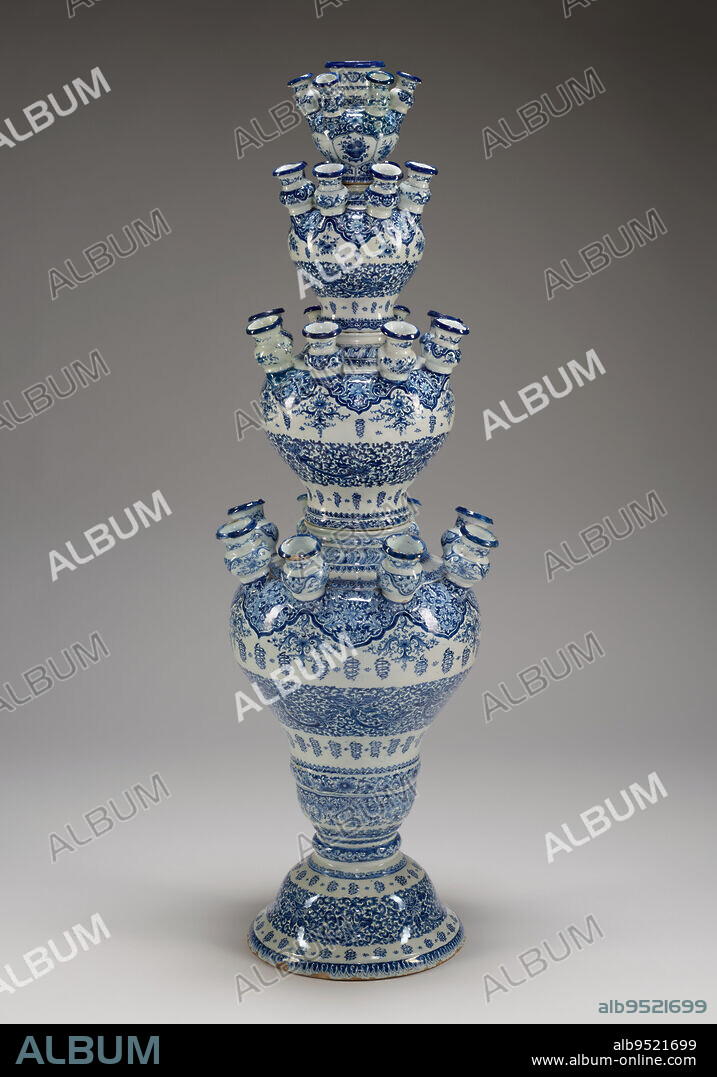 Flower vase, c. 1700, De Witte Ster (The White Star) Factory, 46 1/16 × 15 3/8 × 15 1/4 in. (117 × 39.05 × 38.74 cm) (approx.), Tin-glazed earthenware, pigments, Netherlands, 18th century, 'Tulip mania' reached its height in the 1630s in Europe, with wealthy men and women spending great sums of money to acquire exotic tulip bulbs from the Middle East. More generally, there was enthusiasm for all types of rare flowers, such as marigolds, which came from Mexico via Spain. Potters in Holland created elaborate multitiered vases like this one to showcase colorful blooms. Here, the borders of scrolling lotuses, chrysanthemums, ruyi (scepter heads), and the Chinese character for longevity are copied from decoration on Chinese blue-and-white porcelain vases imported in large quantities in the 1600s. It is unlikely that Dutch craftsmen or customers knew the meaning of these motifs.
