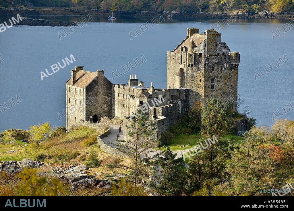 Eilean Donan Castle with autumnal forest, headquarters of the Scottish clan of Macrae, Loch Duich, Dornie, North West Highlands, Scotland, United Kingdom, Europe.