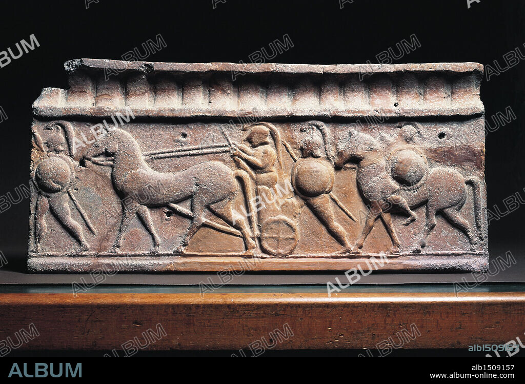 Etruscan civilization, 6th century b.C. Clay slab depicting a warrior in typical Greek armour getting on a chariot. From Arce di Veio Temple.