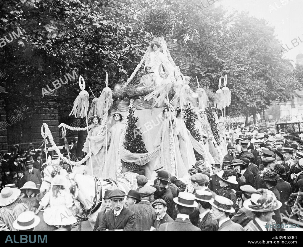 The 'Car Empire' on the Women's Coronation Procession, 17th June 1911. This float was 'the symbol of the unity of the British Empire'. At the top of the car were two figures (only one is visible here) representing East and West, and on the lowest tier were women depicting 'the King's dominions overseas'. Suffragettes from Croydon accompanied the float, which was preceded and followed by young women carrying garlands of red roses, the emblem of England.