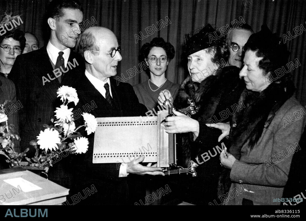Mr. W. ***** presenting Miss Keller with the books and a Braille writing machine. On Miss Keller's left is Miss Polly Thomson her companion and interpreter. Dr. Helen Keller, famous American deaf-blind authoress, whose in home in the U.S.A. was burnt down a few days ago in the fire she lost the whole of her valued Braille library.The National institute for the blind today, (Mon.) presented her with a large number of volumes to help replace ***** of the books lost. December 2, 1946. (Photo by L.N.A.).