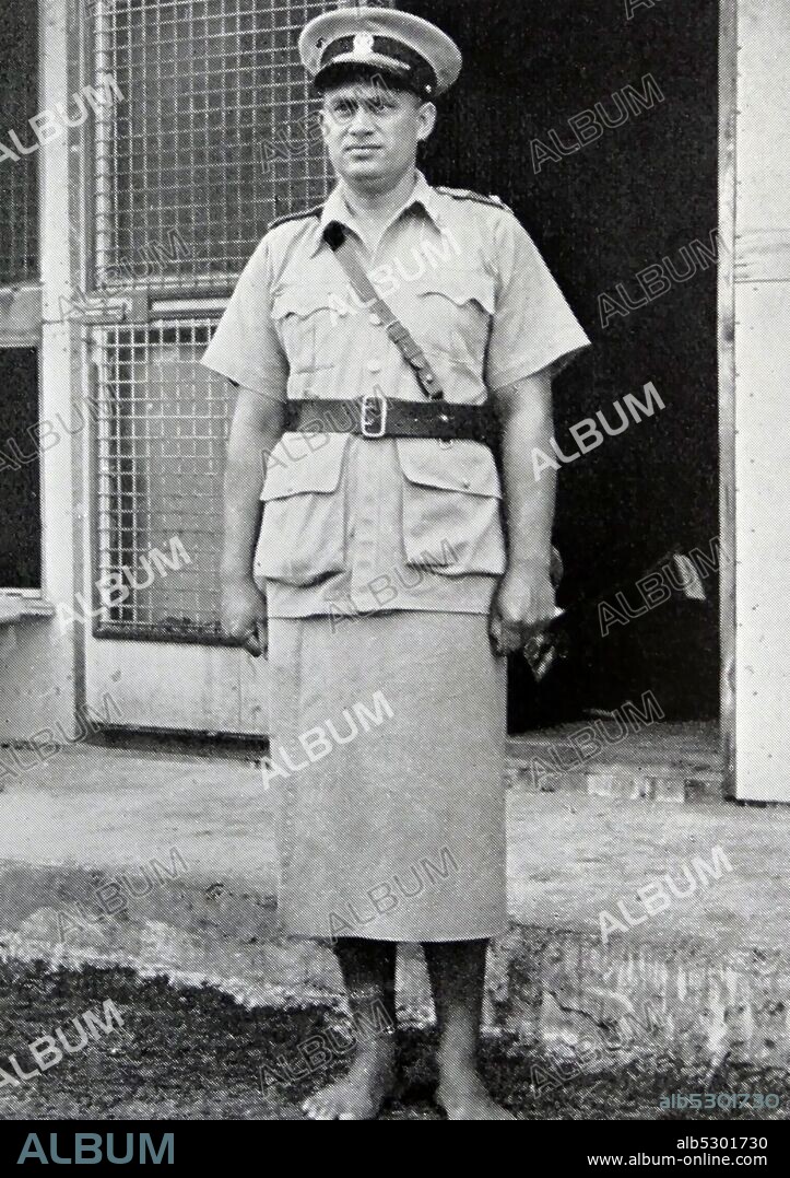 Tongan police officer in kilted uniform. 1950.