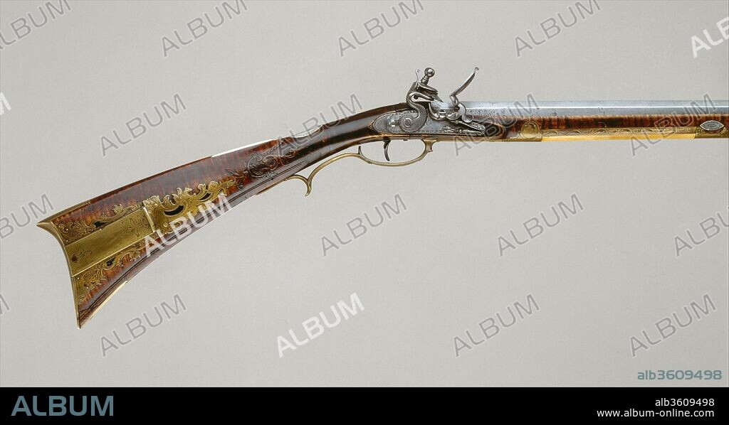 Flintlock Rifle. Culture: American, Pennsylvania. Dimensions: L. 59 1/4 in. (150.5 cm); L. of barrel 43 in. (109.22 cm); Cal. .46 in. (11.7 mm); Wt. 9 lb. 13 oz. (4451 g). Gunsmith: Jacob Kuntz (American, Allentown, Pennsylvania 1780-1876 Philadelphia, Pennsylvania). Date: ca. 1810-15.
This is a classic example of a Pennsylvania longrifle, a uniquely American type of firearm popularly known as a Kentucky rifle. It was probably made around the time that Kuntz moved from Northampton County, Pennsylvania, to Philadelphia. The restrained Rococo carving of the wood and the confident treatment of the engraved brass demonstrate the skills that distinguish Kuntz as one of the finest gunmakers of the period.