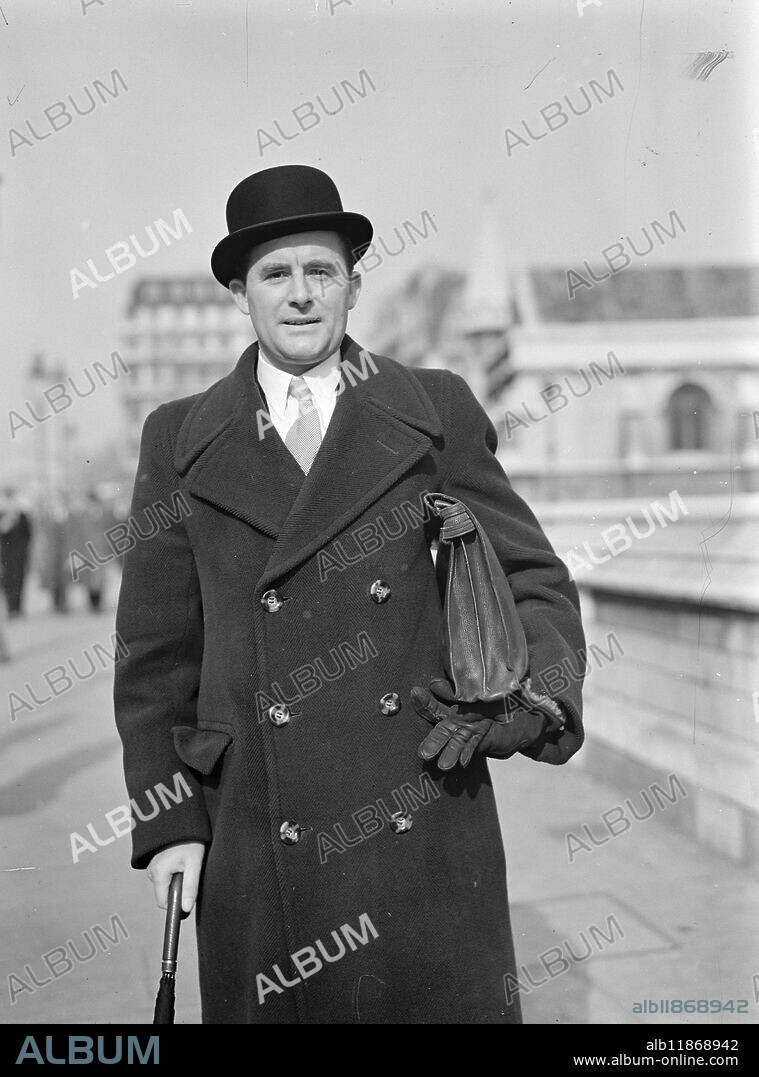 PETERBOROUGH MEMBER ARRIVES FOR PARLIAMENT RE-ASSEMBLY . Mr. Harmar Nicholls, Conservative member for Peterborough arriving at a houses of Parliament today to the election of the speaker and swearing-in of new M.P's. Mr. Nichols, son of a Walsall miner, is a barrister of the Middle Temple, but has not practised. He is in business as a surveyor at Walsall, is keenly interested in local government in Staffordshire and is chairman Darlaston urban district council. The new M.P.is 38. Mr.Nichols had one of the closest fights of the recent general election-he was returned a majority of only 144 over his co-operative and Labour opponents , M.Tiffany. 1 March 1950.