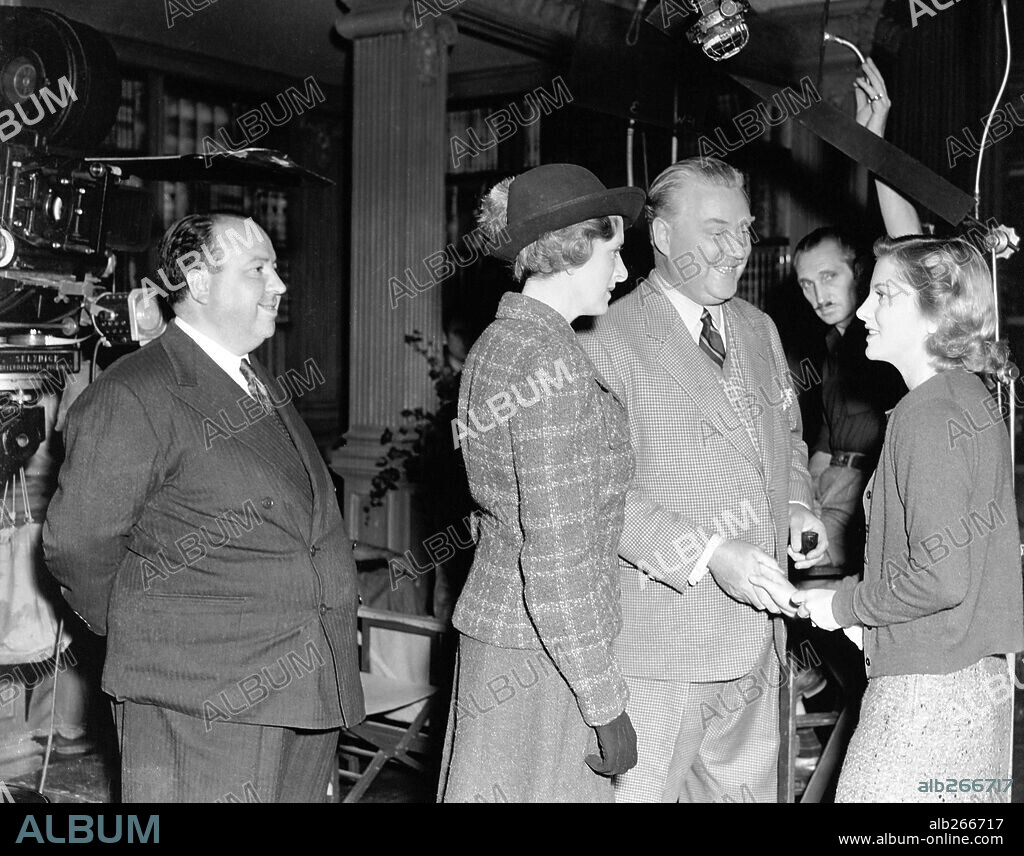 ALFRED HITCHCOCK, GLADYS COOPER, JOAN FONTAINE and NIGEL BRUCE in REBECCA, 1940, directed by ALFRED HITCHCOCK. Copyright Selznick International Pictures.