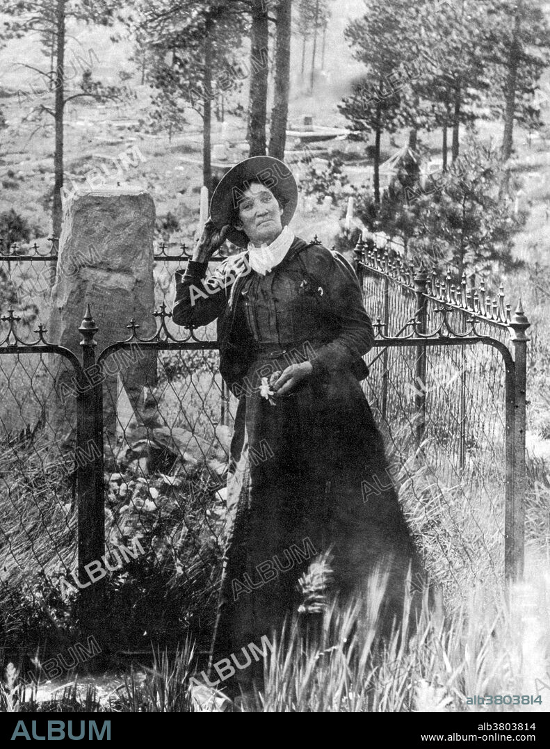 Calamity Jane, standing by the grave of Wild Bill Hickok, photogrpahed by J.A. Kumpf, 1903. Martha Jane Canary (May 1, 1852 - August 1, 1903), better known as Calamity Jane, was an American frontierswoman and professional scout. She received little to no formal education and was illiterate. She worked as a dishwasher, a cook, a waitress, a dance-hall girl, a nurse, and an ox team driver. In 1874, she found work as a scout at Fort Russell. In 1876, she settled in the area of Deadwood and became friendly with Wild Bill Hickok and Charlie Utter. After Hickok's death she continued living in the Deadwood and in late 1876 or 1878, she nursed the victims of a smallpox epidemic. In 1881, she bought a ranch in Montana, along the Yellowstone River, where she kept an inn. In 1893, she started to appear in Buffalo Bill's Wild West as a storyteller. She also participated in the 1901 Pan-American Exposition. She returned to the Black Hills in the early spring of 1903. It was reported that she had been drinking heavily on board the train and became very sick to her stomach. She died soon afterward from inflammation of the bowels and pneumonia. She was buried at Mount Moriah Cemetery, South Dakota, next to Wild Bill Hickok.