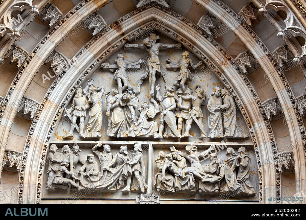 KARL DVORAK. Prague, St. Vitus Cathedral, Central Portal, Western Facade, Tympanum Reliefs Above Bronze Door. Tympanum Reliefs Above the Bronze Door of the central portal in the St. Vitus Cathedral's western facade, depicting The Crucifixion and a game of dice in order to win Christ's garments. This work was carved circa 1949.