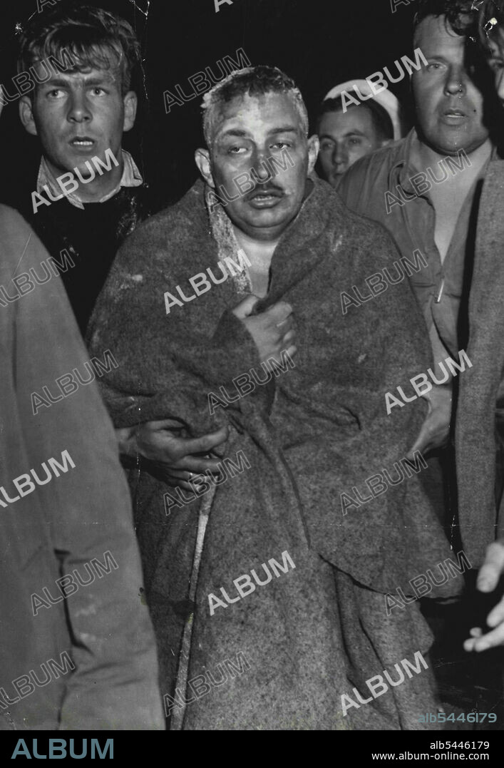 Exhausted Channel Swimmer, Jorge Berroeta, a Chilean, coming ashore at Dover, Kent, after his attempt to make the crossing. Forced back by an ebb tide when half a mile from Dover. Berroeta abandoned his attempt. Edward Temme (right) the trainer, has swum the Channel both ways. August 31, 1946. (Photo by The Associated Press Ltd.).