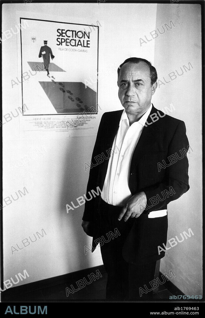 Leonardo Sciascia next to a poster. Leonardo Sciascia next to the poster for the film 'Special Section', directed by Constantin Costa-Gavras.