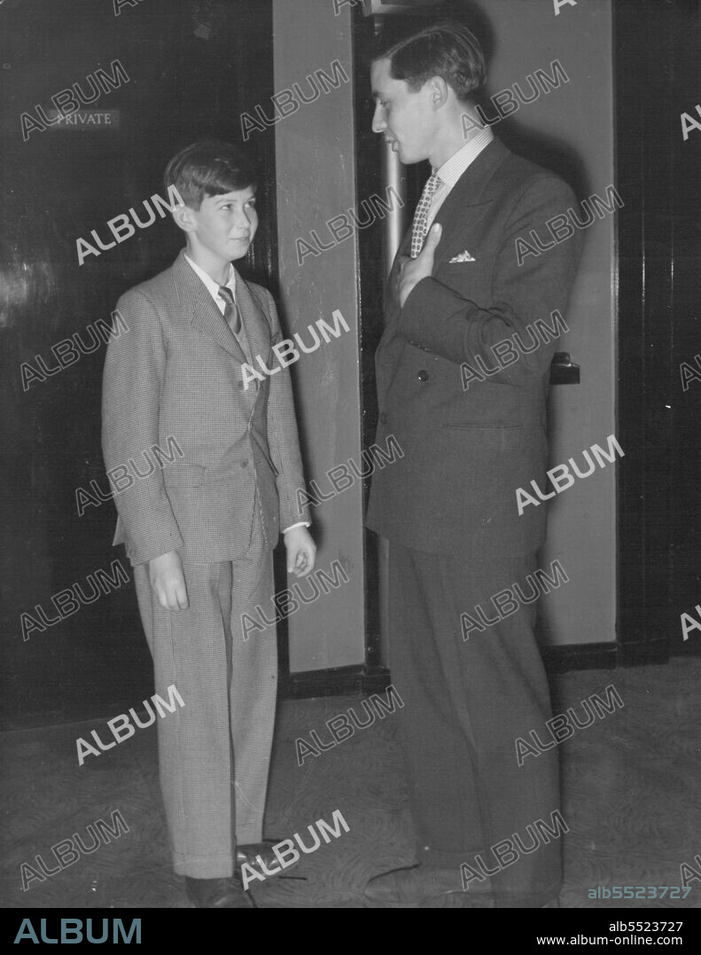 Prince Michael Says Mine's An Ice -- Twelve-year-old Prince Michael of Kent, arrives at the London Casino last night with his tutor, Mr. Timothy Dawson. The Prince's long-trouser suit: light-grey tweed.They watched the film show from the stalls, and during the interval were invited by manager Mr. Pat Spellman into his office. Said Mr. Spellman: "I don't suppose you will want champagne." So he offered then soft drinks.Mr. Dawson had a glass of orangeade. Prince Michael chose ice-cream instead. He ate it out of a carton. December 21, 1954. (Photo by Evening Standard Picture).