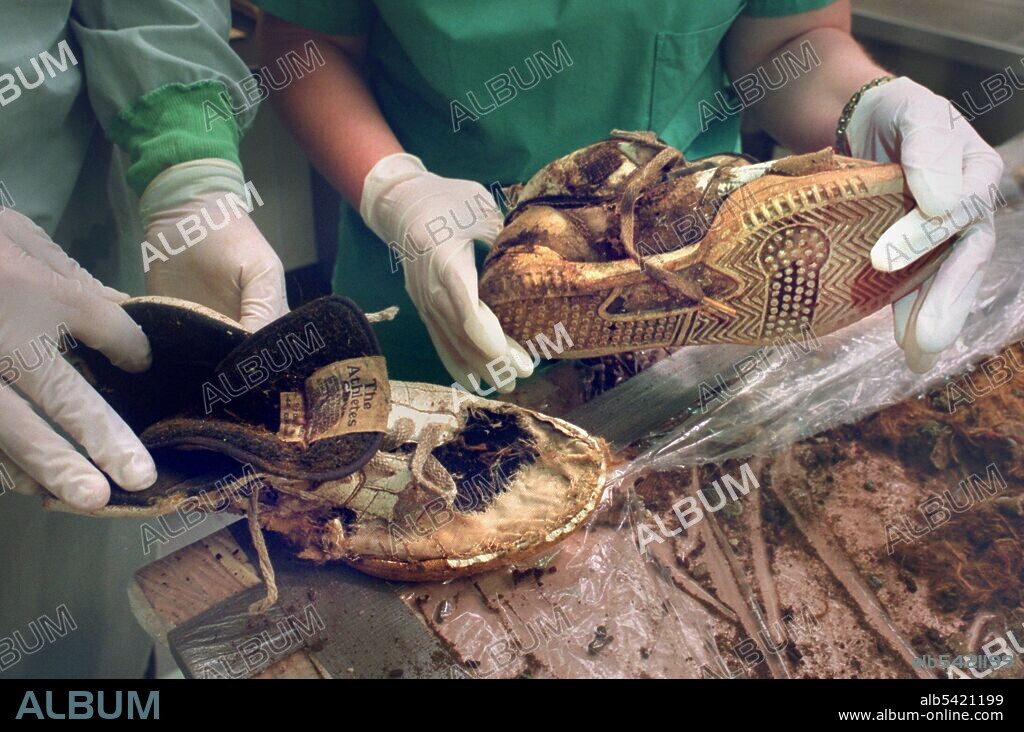 Yolo County coroners hold the shoes found with a decomposed body that helped them identify the 14-year-old remains as those of Anthony Ruiz. Photo taken at the morgue in Woodland Friday January 11, 2002. (Sacramento Bee/ Leilani Hu) /ZUMA Press.