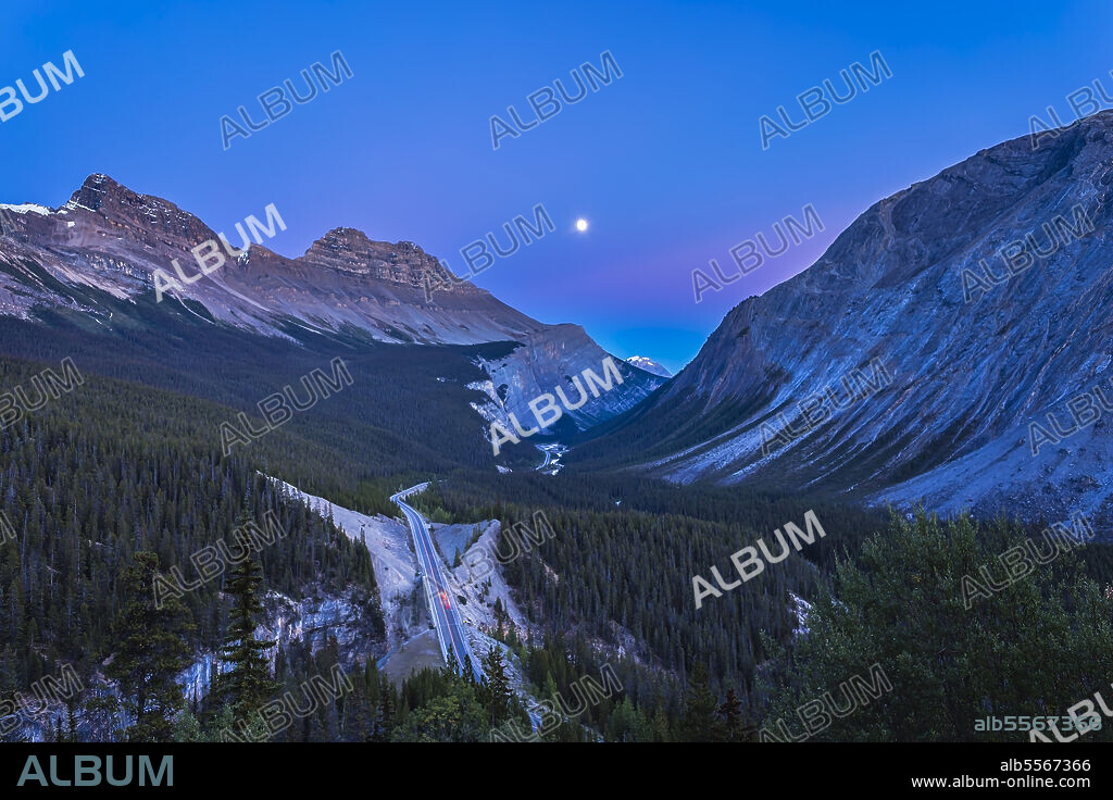 The waxing gibbous moon over the Icefields Parkway from the Cirrus Mountain viewpoint at the top of the Big Bend. The valley below is the classic U-shaped glacially carved valley.