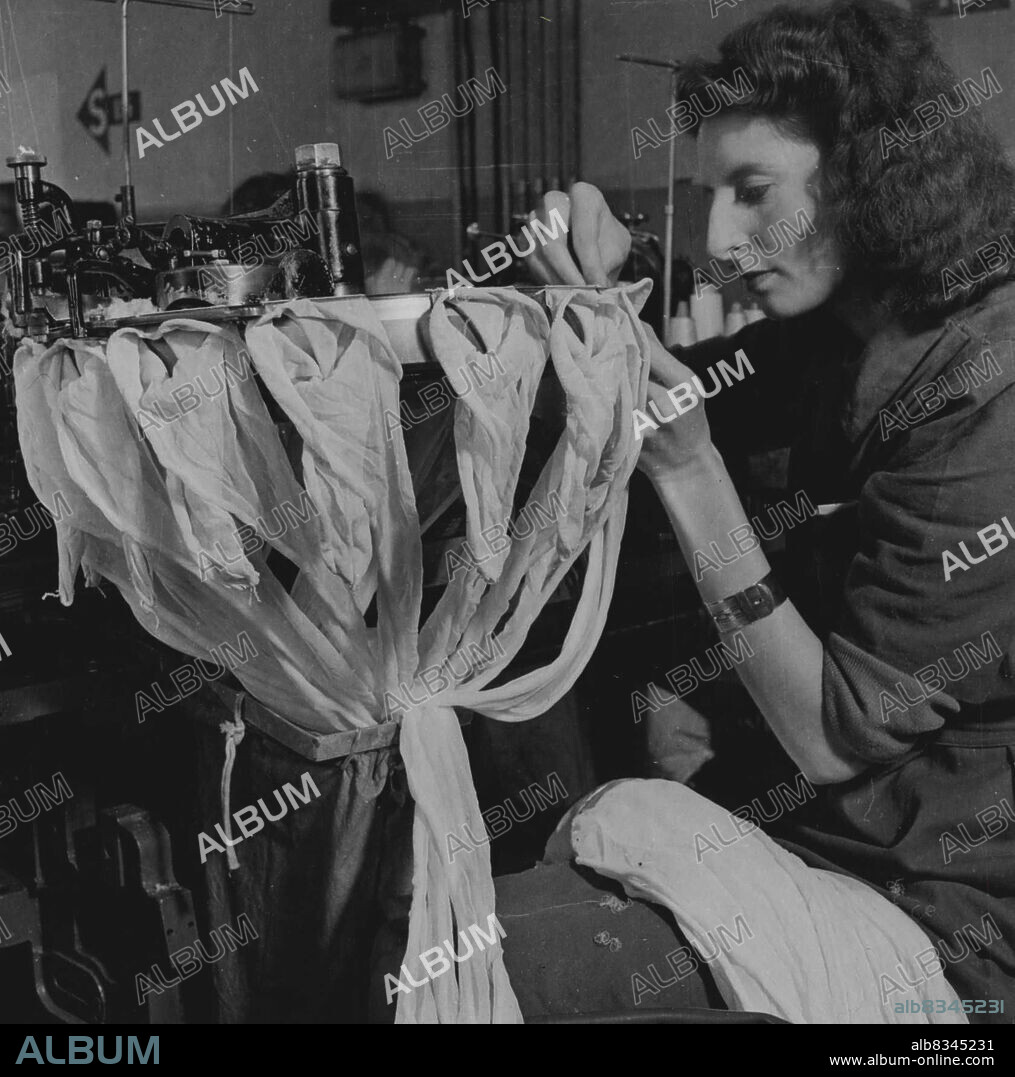 Scenes At Kayser Bond Hosiery Factory At Baldock, Herts - Linking machine where the heels and soles are joined rough edges are out off before joining process begins.Nylon stocking, which will bring glamour with durability to the thousands of women who have been waiting for them all during the war years will soon be on sale in the shops. At present the manufacturer of "Nylons" - the sheerest of silk stockings is, in this country, only in the development stage. Great progress and excellent results have already been achieved, but there will be very few released for distribution until British products have been fully tested. July 12, 1946. (Photo by Topical Press).