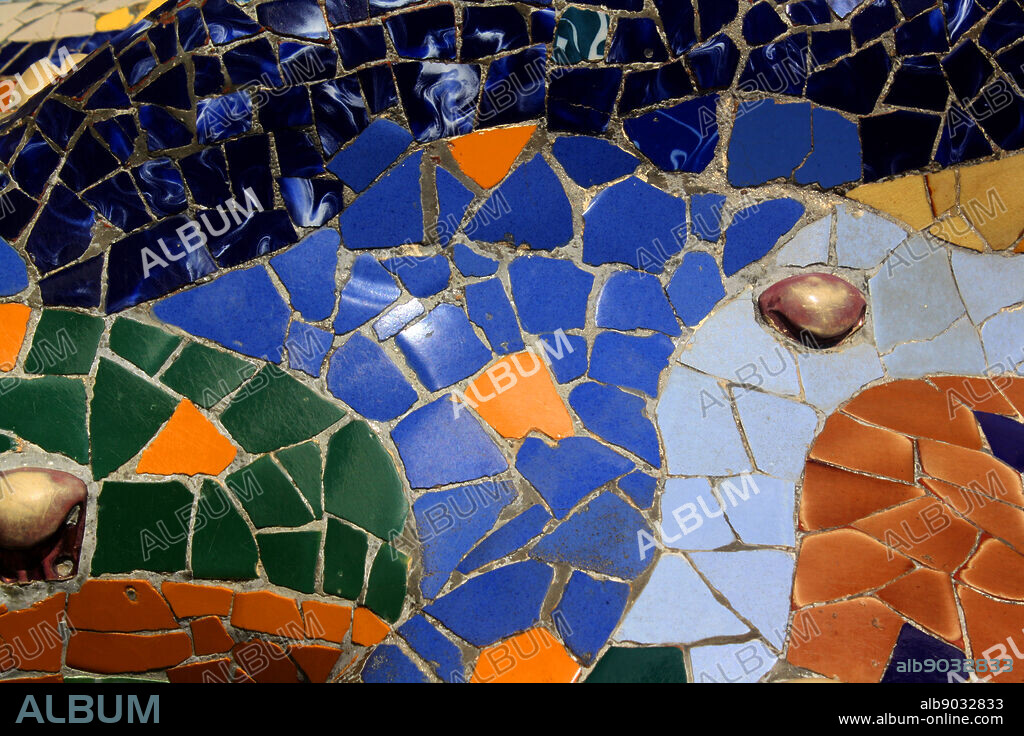 Mosaic lizard at Antoni Gaudi's Parc Guell, Barcelona, Spain. Park Güell is a garden complex with architectural elements situated on the hill of El Carmel in the Gràcia district of Barcelona, Catalonia, Spain. It was designed by the Catalan architect Antoni Gaudi and built in the years 1900 to 1914. It is part of the UNESCO World Heritage Site 'Works of Antoni Gaudi.