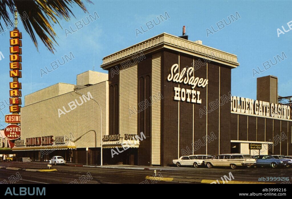 Golden Gate Casino and Sal Sagev Hotel, Las Vegas, Nevada, USA, 1966. Vintage postcard showing the exterior of the Sal Sagev Hotel and Golden Gate Casino on Fremont and Main Streets. The brown and cream buildings sit on the corner and cars are parked in the parking lot. Large neon signs from both establishments are visible. The Sal Sagev Hotel originally opened in 1906 as the Nevada Hotel, before being renamed (the name is simply Las Vegas spelled backwards) in 1931. It became the Golden Gate in 1955 when a group of Italian Americans from San Franccisco started up a casino on the premises.