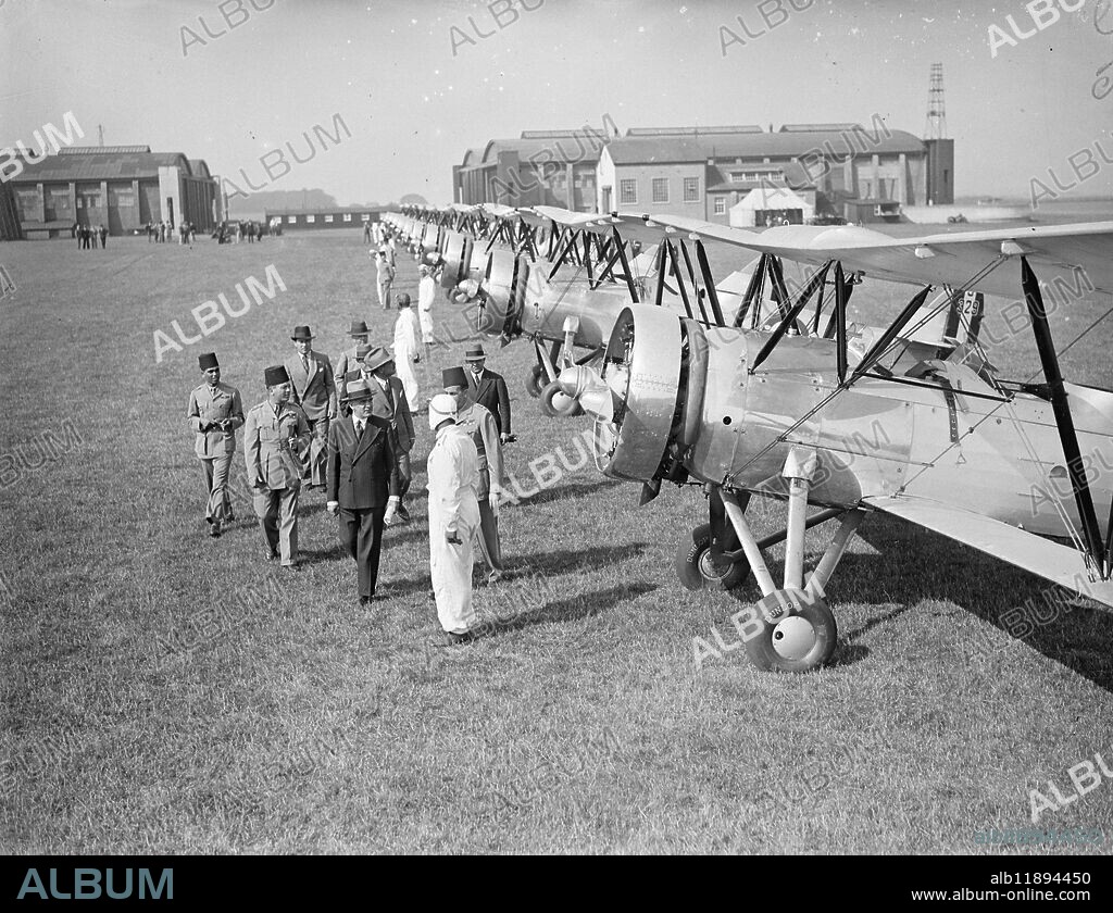 Egyptian air squadron tested at Lympne before formation flight to Egypt . To be used to suppress dope smuggling . A fleet of ten Avro biplanes built in England for the Egyptian Government underwent tests and official inspection at Lympne Aerodrome , Kent , before taking off for a formation flight to Cairo . The planes will be used in Egypt for military purposes and in suppressing the drug traffic . Photo shows the Egyptian Charge d ' Affaires in London , H E Hakki Bey , inspecting the squadron at Lympne . 14 September 1934.