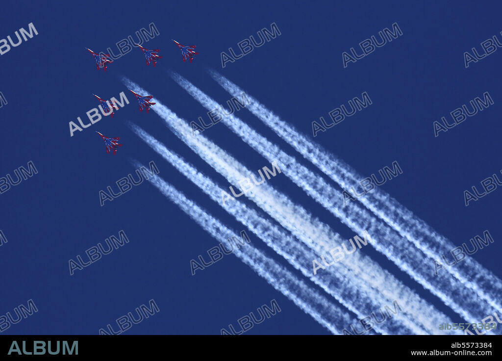 MiG-29 jet fighters of Strizhi (Swifts) aerobatics team of the Russian Air Force on a high altitude with contrail, Kubinka, Russia.