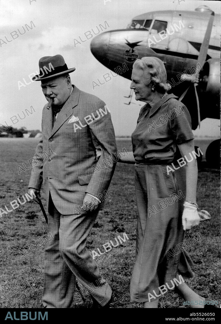 Wifely Gesture - Mrs. Churchill grasps her husband's arm as he leaves the plane at Biggin Hill Royal Air Force field, Kent.Mr. Winston Churchill, now completely recovered from the chill he contracted while swimming during his Riviera stay, arrived by plane at Biggin Hill Airfeld, Kent, near his home at Westerham, after his Continental holiday. He was met on arrival by Mrs. Churchill. September 01, 1949.