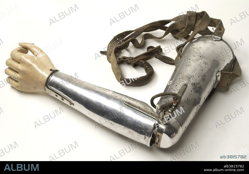 Artificial metal left arm with hand and canvas shoulder strap. Made by the Mckay Artificial Limb Company. Photograph from 1927.