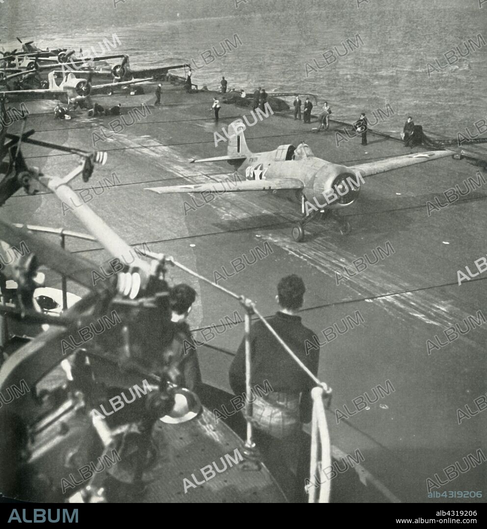 Fighter planes on board an aircraft carrier, Second World War, c1943. 'A Martlet [Grumman F4F Wildcat] of the Fleet Air Arm, bearing American markings, flies off a British carrier during the African operations, while other Martlets and Seafires are ready to follow. The Fleet Air Arm protected the [Royal Navy] Fleet and transports, covered the landings, and supported the advance.' The FAA is the section of the Royal Navy responsible for the operation of naval aircraft. From "Fleet Air Arm". [His Majesty's Stationery Office, London, 1943].