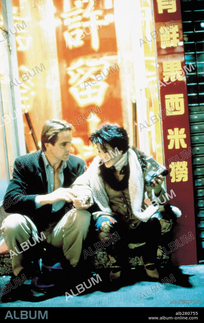 JEREMY IRONS and LI GONG in CHINESE BOX, 1997, directed by WAYNE WANG. Copyright TRIMARK PICTURES.