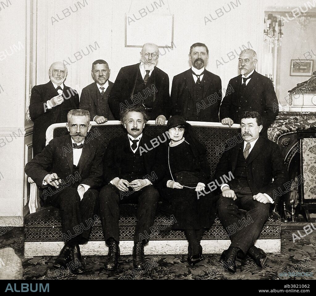 Lunch in honor of Albert Einstein, with (front row) Langevin, Einstein, Comtesse de Noailles, Painleve. Albert Einstein (March 14, 1879 - April 18, 1955) was a German-born theoretical physicist who developed the general theory of relativity, effecting a revolution in physics. Einstein is often regarded as the father of modern physics and the most influential physicist of the 20th century. While best known for his mass-energy equivalence formula E = mc2, he received the 1921 Nobel Prize in Physics for his services to theoretical physics, and especially for his discovery of the law of the photoelectric effect. The latter was pivotal in establishing quantum theory within physics.