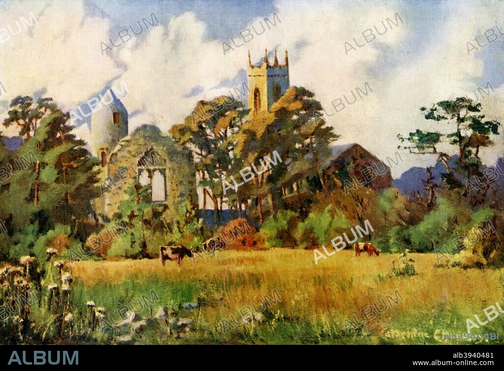 Dromiskin Church, County Louth, Ireland, 1924-1926. A medieval Irish round tower stands to the left of the church tower. A print from Hutchinson's Britain Beautiful, edited by Walter Hutchinson, volume III, 1924-1926.