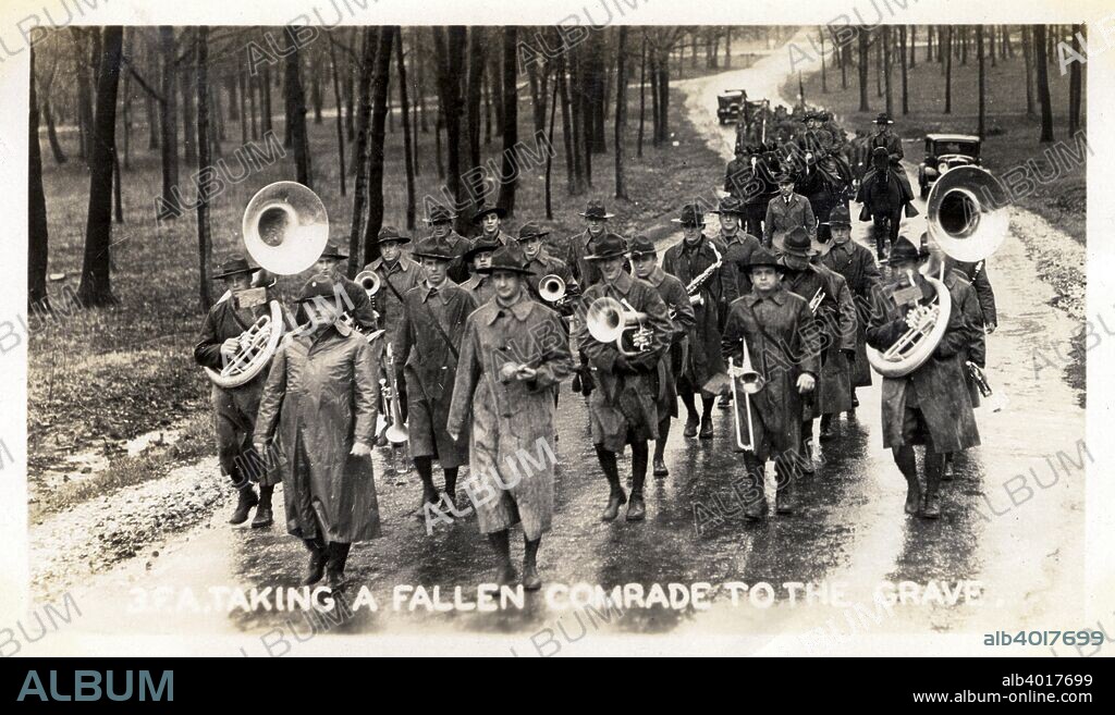 Taking a fallen comrade to the grave, Fort Sheridan, Illinois, USA, 1930. A funeral procession with soldiers carrying musical instruments. Fort Sheridan was a US Army base on the shores of Lake Michigan just north of Chicago.