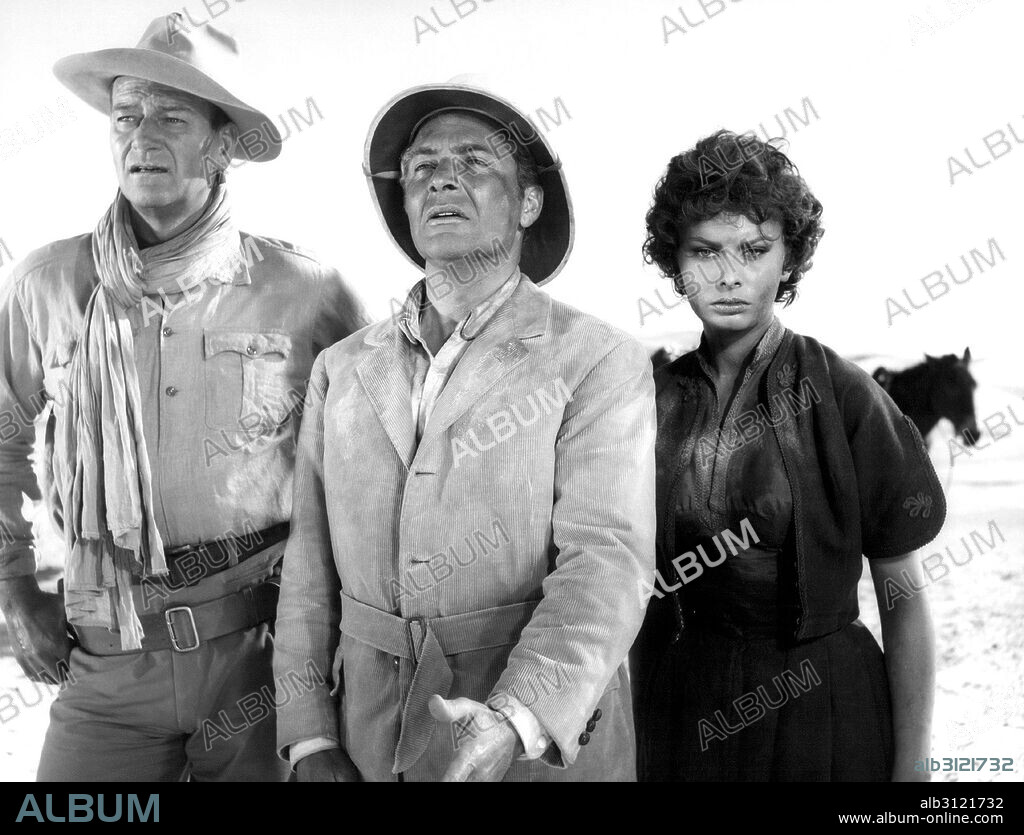 ROSSANO BRAZZI, LOREN SOPHIA / LOREN SOFIA 1934/ and JOHN WAYNE. JOHN WAYNE, ROSSANO BRAZZI and SOPHIA LOREN in LEGEND OF THE LOST, 1957, directed by HENRY HATHAWAY. Copyright UNITED ARTISTS.