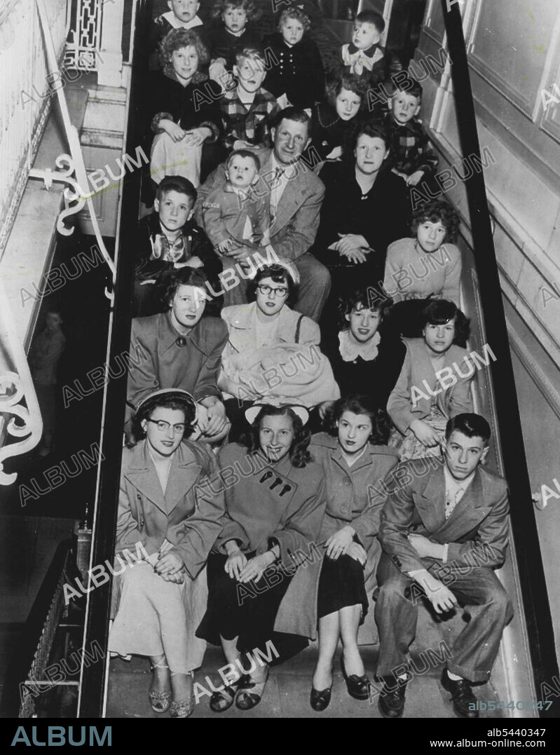 They Certainly Know The Score - And More - Here is a family 22 which happens to be one-thirty-seventh of the population of Soldiers Grove, Wisconsin 50 miles southeast of LaCrosse. Picture was made at Morrison hotel here as family came to Chicago for an outing. Here they are: Front row (l. to r.) Mrs. Marjorie ***** Mrs., Lola Underwood, Mrs. Betty Burnett and Marlin Schoville; second row, Mrs. Phyllis Benson, Donna Schoville (holding Stephen, one month old), Annabelle and ***** Schoville; third.