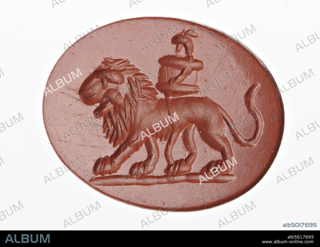 Vz: a lion walks with a basket tied to his back, probably the cista mystica., Gem, intaglio, ringstone, jasper, Color: red, Shape: oval, Processing: edge at the back receding cut compared to front, Method: coarse body modeling with a large rounded drill, detailing with short wheel grooves., 14 x 11 mm, D. 4 mm, 2nd - 3rd century AD. 100-300 AD.