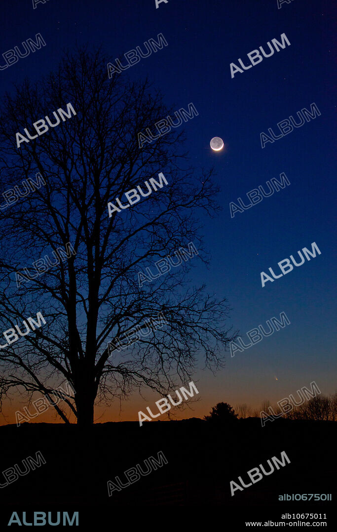 Comet Pan-STARRS (bottom right) shares the sky with a 2 day old moon in this picture taken March 13, 2013 from Dover, New Hampshire.