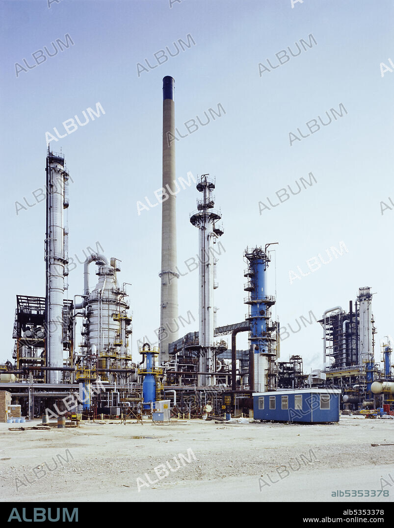 JOHN LAING PLC. An exterior view of the newly completed Alkylation Unit at Lindsey Oil Refinery. Laing Industrial Engineering and Construction Limited (IEC) were involved in the construction of a Hydrofluoric Acid (HF) Alkylation Unit at Lindsey Oil Refinery. There were many other sub-contractors on site, with Foster Wheeler as the main contractors. The project team began work on the site in May 1979. To keep the site dry and speed up progress, a 'Plettac' covering made up of numerous small panels was constructed over the site. Work carried out by Laing IEC included the installation of thirteen thousand metres of pipework, 1400 valves, 30 heat exchangers, 18 drums and vessels, and 23 pumps.