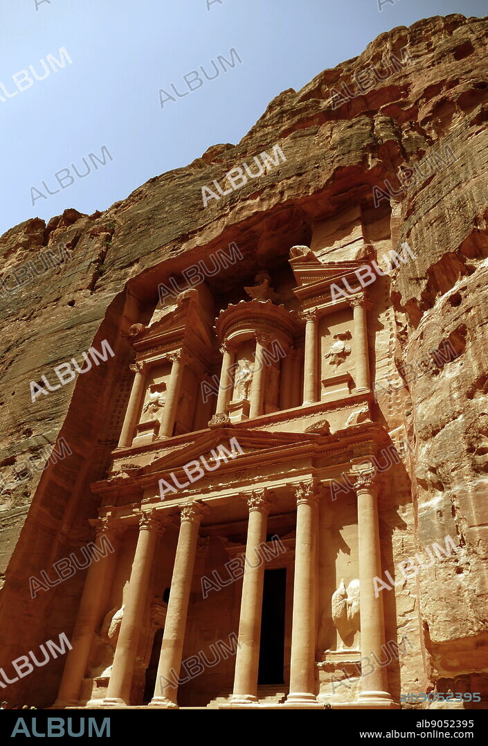 Al-Khazneh (The Treasury) a temple in the ancient Nabatean Kingdom city of Petra, Jordan. The structure was carved out of a sandstone rock face and is believed to have been the mausoleum of the Nabatean King Aretas IV in the 1st century AD. It is one of the most popular tourist attractions in both Jordan and the region. In 1812, the city of Petra and Al-Khazneh was rediscovered by Swiss explorer Johann Ludwig Burckhardt.