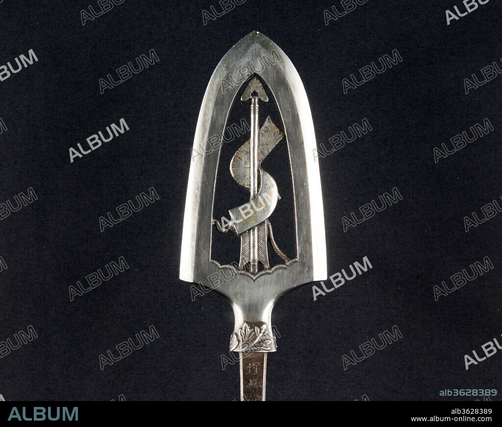 Ceremonial Arrowhead (Yanone). Culture: Japanese. Dimensions: L. 10 5/8 in. (27 cm); L. of head 4 1/16 in. (10.3 cm); W. 1 7/8 in. (4.8 cm); Wt. 3.8 oz. (107.7 g). Steel-chiseler: Umetada Motoshige (Japanese, Edo period, died 1675). Date: dated 1645.
Large arrowheads, pierced and elaborately chiseled with landscapes, birds, flowers, dragons, and Buddhist divinities, were created to be admired for the beauty of their metalwork and design rather than for use in archery. This arrowhead is dated 1645 and signed by Umetada Motoshige (died 1675), a member of the Umetada school of swordsmiths, <i>tsuba</i> makers, and iron chiselers. It belongs to a group of more than thirty similarly signed and dated pieces in the Metropolitan Museum's collection (including acc. nos. 32.75.318, .321, .327, .330, .334, .337, .339-.340, .398-.399, .403, .406) that may have been made for presentation or as a votive offering to a shrine. The design is an arrow entwined with a paper on which a poem is written.