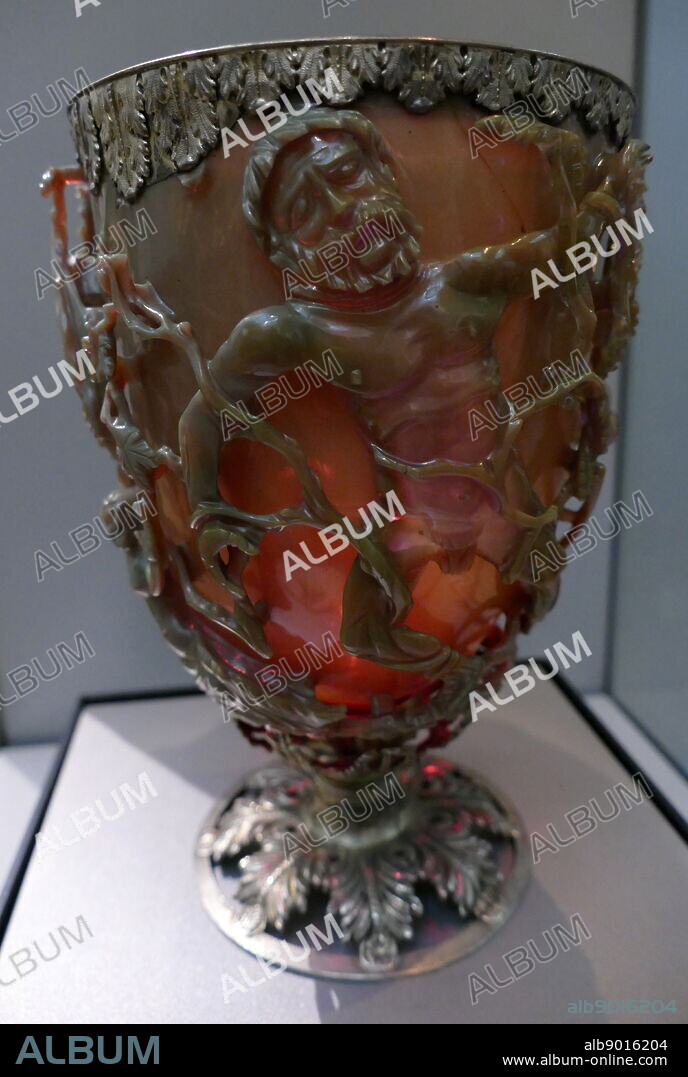 The Lycurgus Cup; 4th-century, Roman glass cage cup. Made of a dichroic glass, which shows a different colour depending on whether or not light is passing through it; red when lit from behind and green when lit from in front. It is the only complete Roman glass object made from this type of glass. The cup is also a very rare example of a complete Roman cage-cup, or diatretum. It named after King Lycurgus.