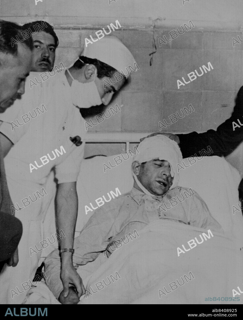 Trotsky Attacker In Hospital -- Frank Jackson recovering in a Mexico City hospital from a beating by Leon Trotsky's guards, after fatally wounding the exiled Russian Revolutionist in the head with a Pickax. Holding a hand on Jackson's head is General Jose Manuel Nunez, Mexico City Chief of Police. August 22, 1940. (Photo by ACME).