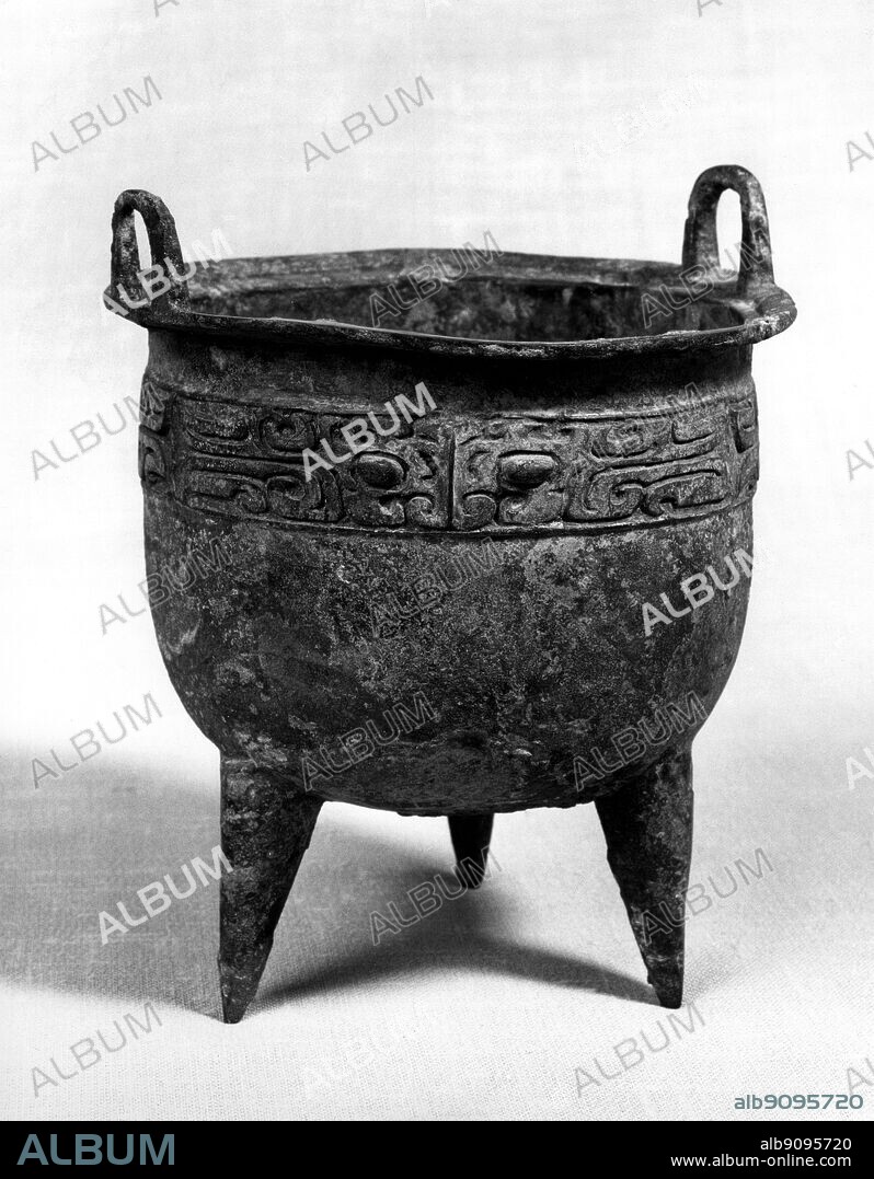 Bronze ritual tripod vessel ting , with monster mask , excavated in 1955 at Pai chia chuang , Cheng chou , Honan . Shang Dynasty 16th - 15th BC.