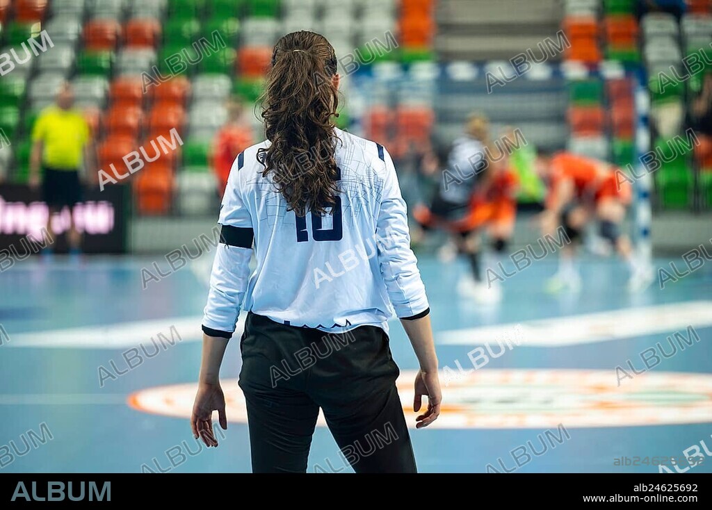 Handball woman goalkeeper's back and handball match in the background in Lubin, Poland