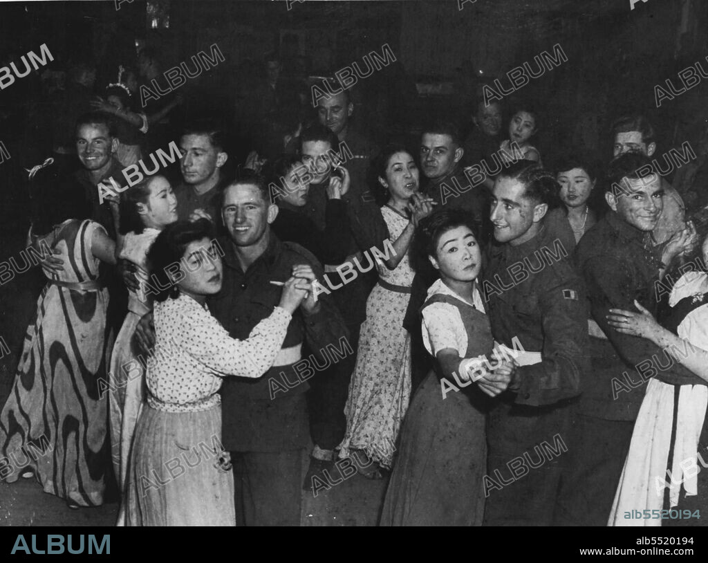 Aussies At Dance Hall At Kure -- Japs Taxi Dancers, soon modern style dancing. Dance Hall Specially erected by Japs to entertain Aussies. Cost is 5 yen admission and 3 yen per dance.Men not allowed to see partners home after Dance.Japanese taxi-dancers at Kure. They pay to dance and are not allowed to take the girls home afterwards. March 19, 1946.