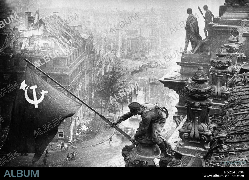 Red army soldiers raising the soviet flag over the reichstag in berlin, germany, april 30, 1945, photo taken by vladimir grebnev. 01/02/2013