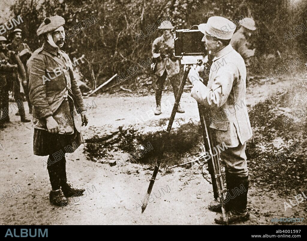 Cameraman filming a wounded soldier, Somme campaign, France, World War I, 1916. The French official cinematographer at work filming a wounded Scottish soldier.