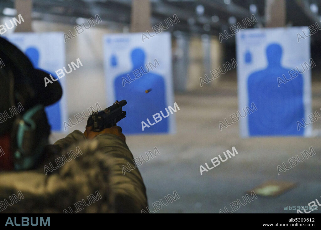 March 1, 2021, Chicago, Illinois, USA: ARIEL CHARLES fires a pistol during a target practice class at Eagle Sports Range in Oak Forest. A Northwestern University study found that while white people bought more firearms overall last year, African Americans made up a disproportionate number of first-time gun buyers. (Credit Image: © Youngrae Kim/Chicago Tribune/TNS via ZUMA Wire).