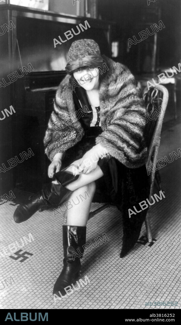 Woman putting flask in her Russian boot. Flappers were a "new breed" of young Western women in the 1920s who wore short skirts, bobbed their hair, listened to jazz, and flaunted their disdain for what was then considered acceptable behavior. Flappers were seen as brash for wearing excessive makeup, drinking, treating sex in a casual manner, smoking, driving automobiles, and otherwise flouting social and sexual norms. Prohibition in the US was a nationwide Constitutional ban on the sale, production, importation, and transportation of alcoholic beverages that remained in place from 1920 to 1933. Prohibition was mandated under the 18th Amendment to the US. Constitution. Enabling legislation, known as the Volstead Act, set down the rules for enforcing the ban and defined the types of alcoholic beverages that were prohibited. Nationwide Prohibition ended with the ratification of the 21st Amendment, which repealed the 18th Amendment, on December 5, 1933. National Photo Company Collection, January 22, 1922.