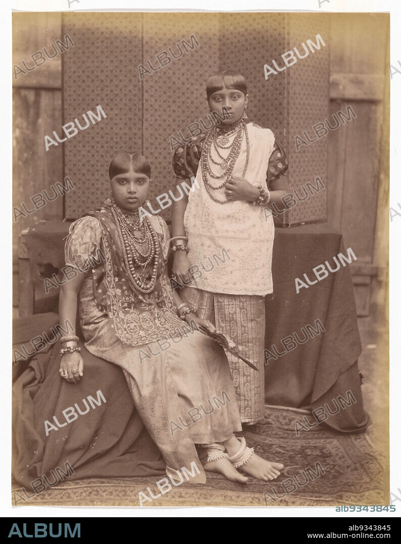 Portrait of two unknown women from the kingdom of Kandy, dressed in traditional clothing and wearing traditional jewelry, anonymous, Sri Lanka, 1870 - 1890, paper, albumen print, height 277 mm × width 213 mm.
