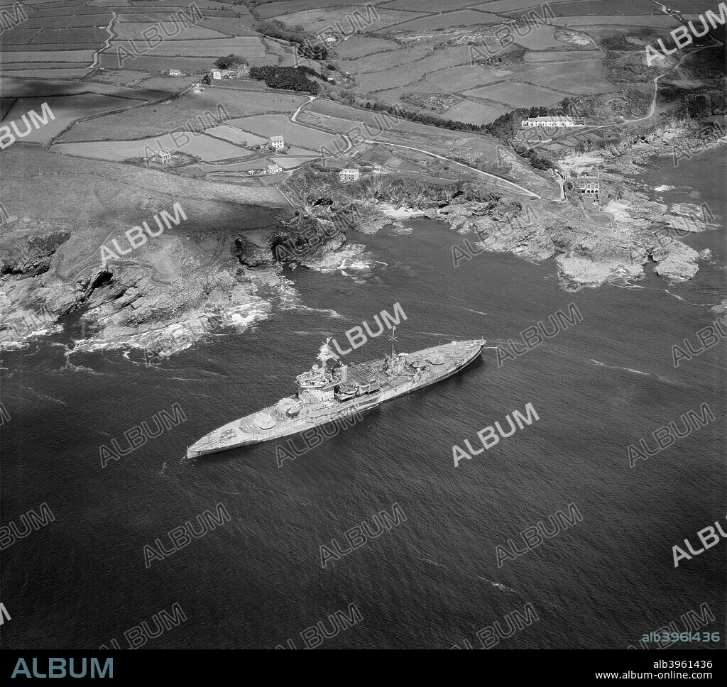 HMS 'Warspite', Prussia Cove, Cornwall. 'Warspite' was launched in 1913 and saw action with the Royal Navy at the Battle of Jutland in 1916. During the second world war she saw service off Norway, Italy, in the Indian Ocean, Sicily and Normandy. Plagued by steering problems almost from the outset this Queen Elizabeth class battleship was finally sold for scrap in 1947. Photographed here in May 1947, she is seen here having run her anchor during a storm and run aground while on her way to be broken up.