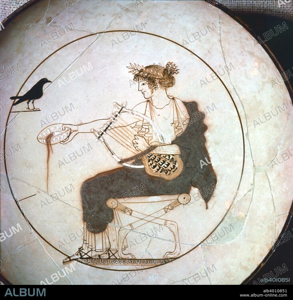 Attic White Ground kylix of the early 5th century BC.  Showing Apollo sitting on a stool performing a libation whilst holding a lyre. A raven looks on. This scene posibly could allude to the myth of King Phlegyas's daughter Koronida (from the Greek korone, raven), who was in love with Apollo, although some scholars believe it is simply a bird with prophetic powers. From the Archaeological Museum of Delphi.